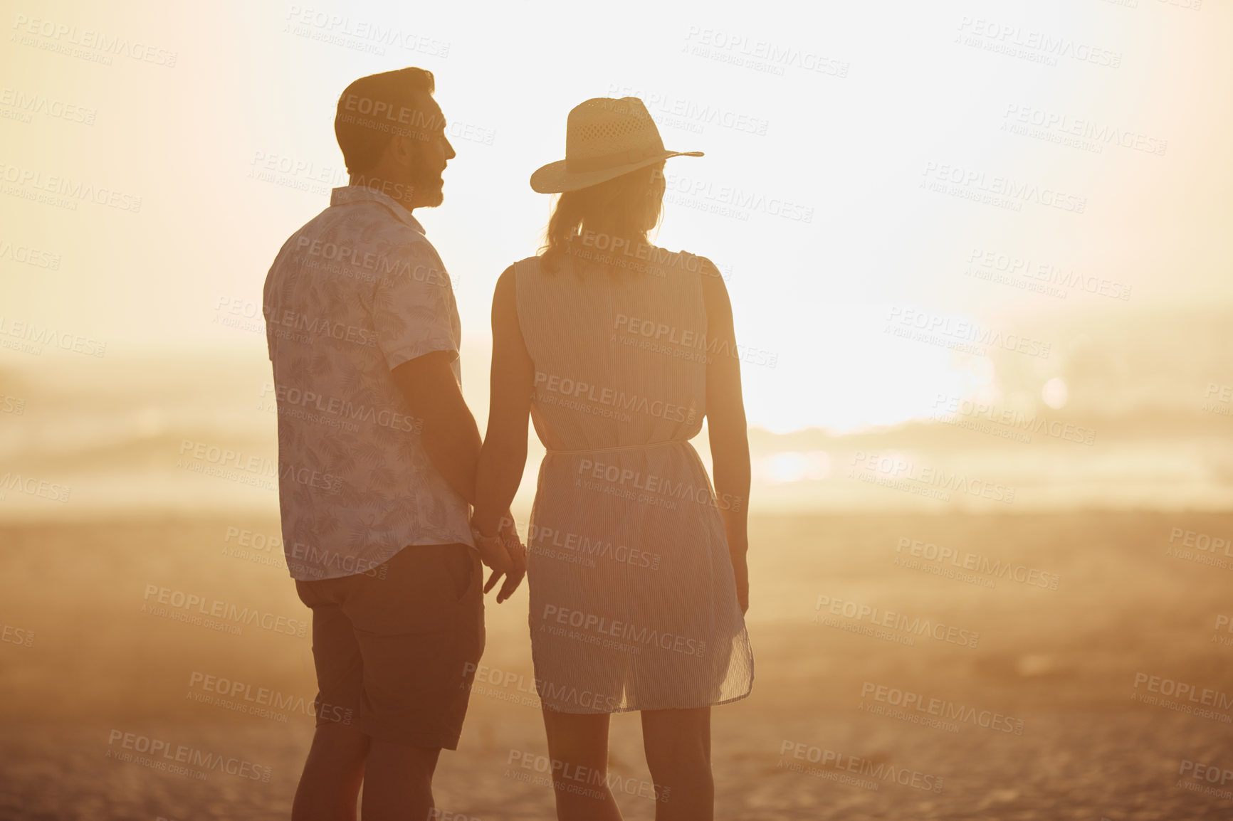 Buy stock photo Rearview shot of a mature couple spending quality time on the beach