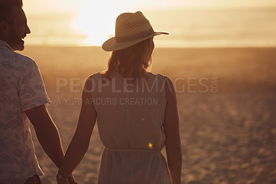 Buy stock photo Rearview shot of a mature couple spending quality time on the beach