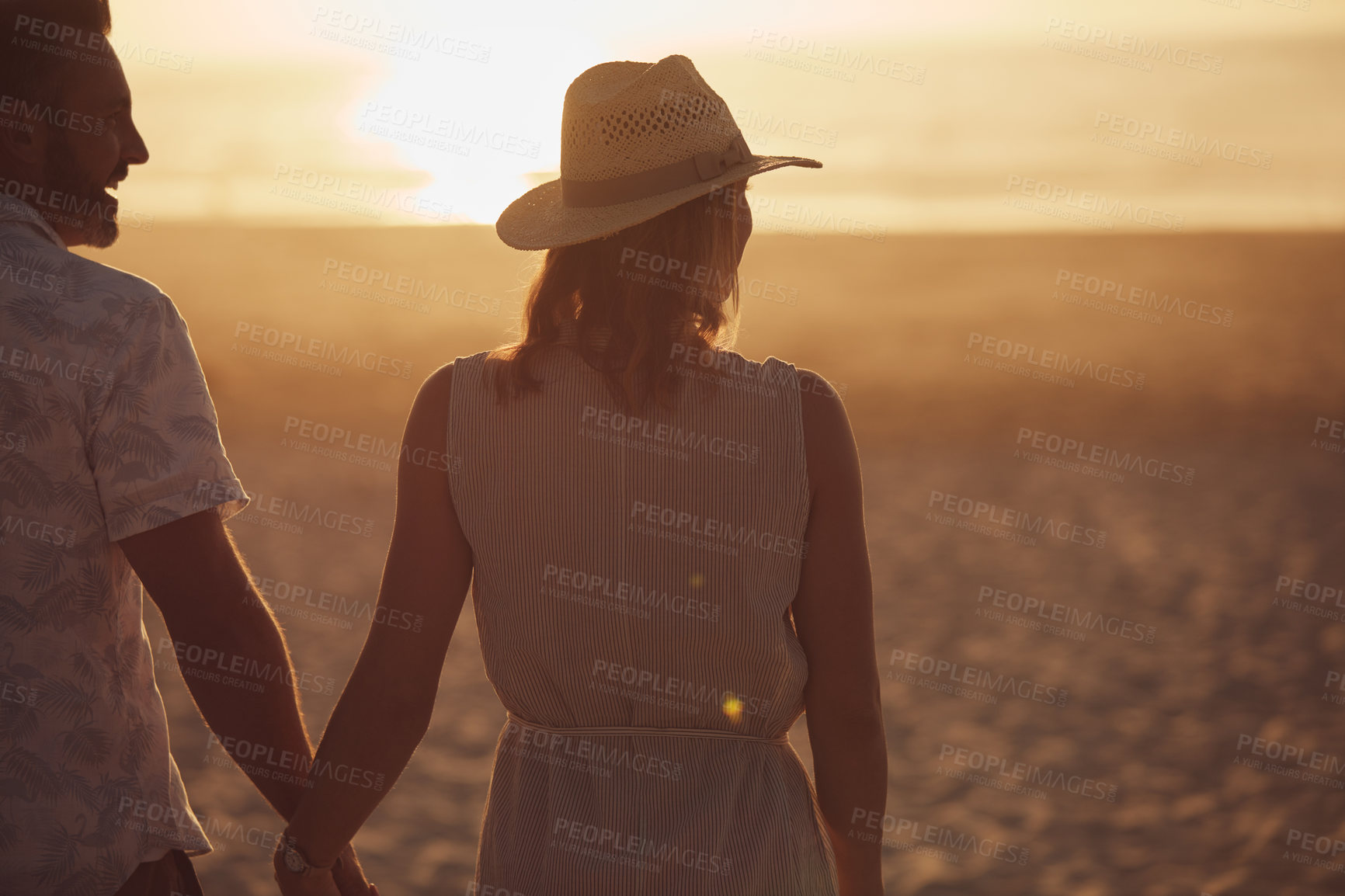 Buy stock photo Rearview shot of a mature couple spending quality time on the beach