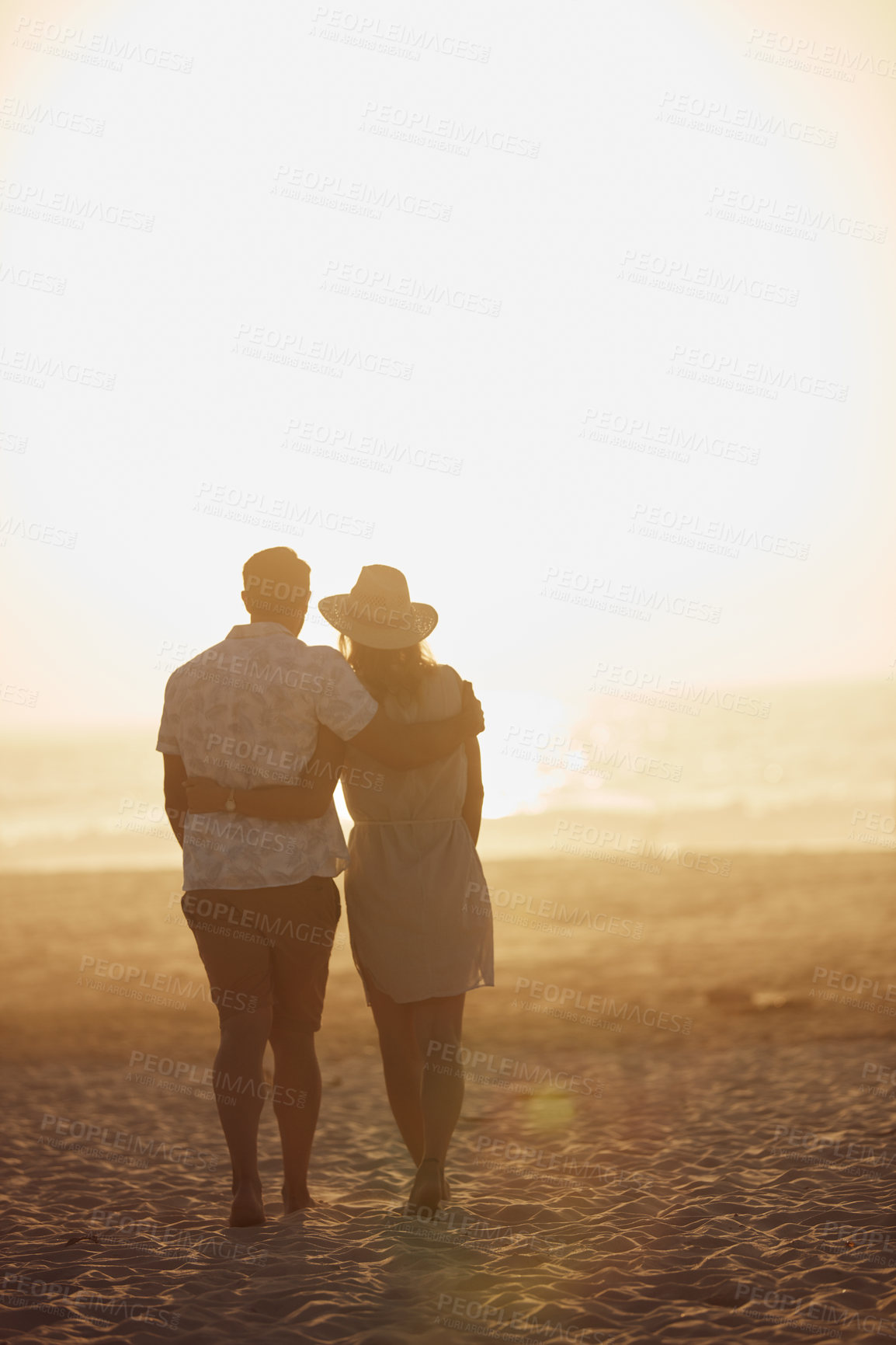 Buy stock photo Rearview shot of a mature couple spending quality time on the beach