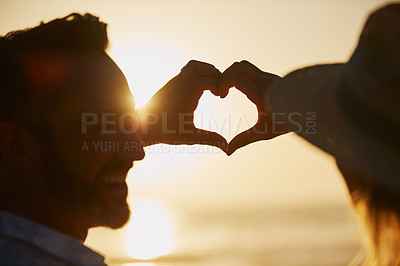 Buy stock photo Shot of an affectionate mature couple forming a heart shape with their hands