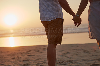 Buy stock photo Rearview shot of a mature couple spending quality time on the beach