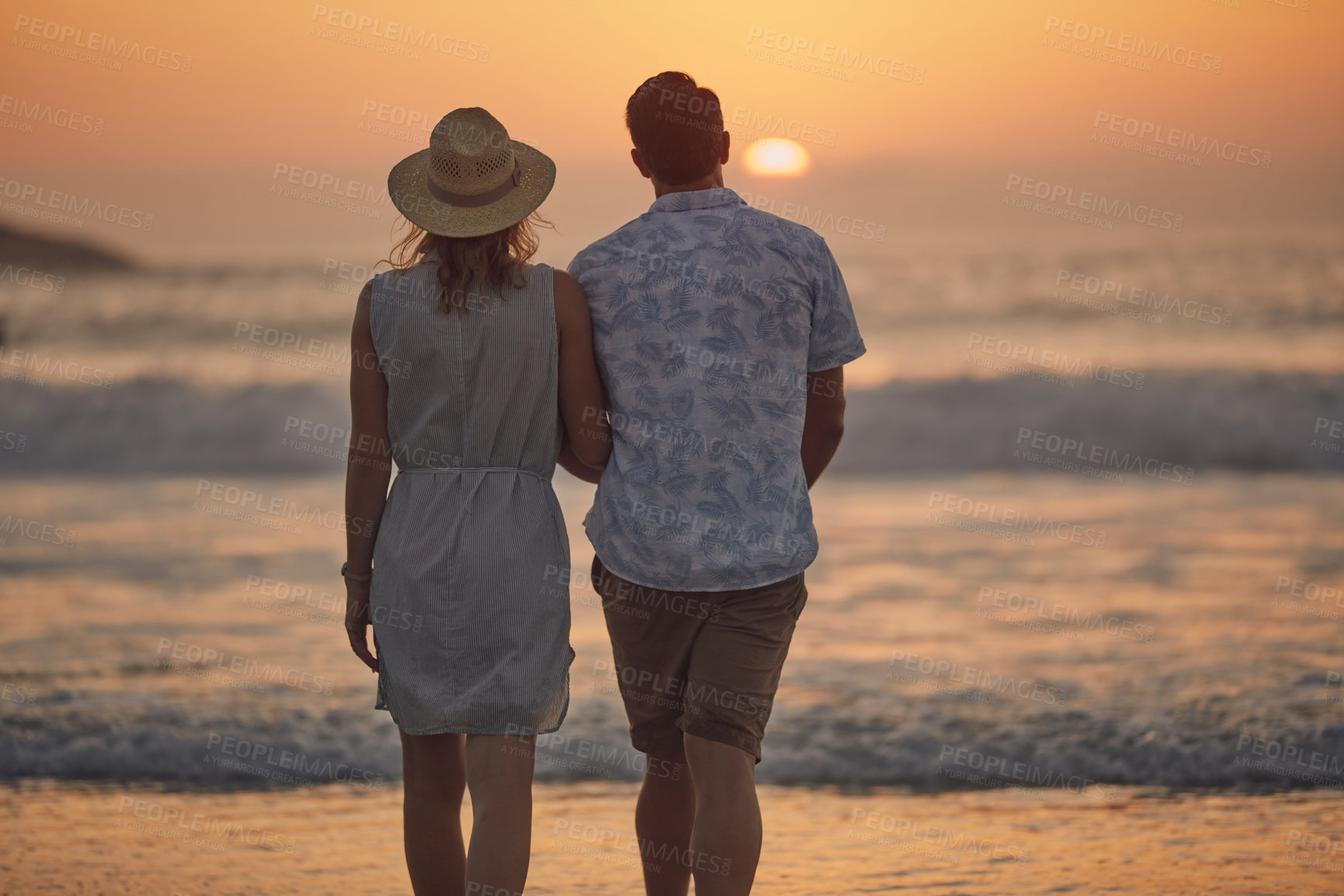 Buy stock photo Rearview shot of a mature couple spending quality time on the beach