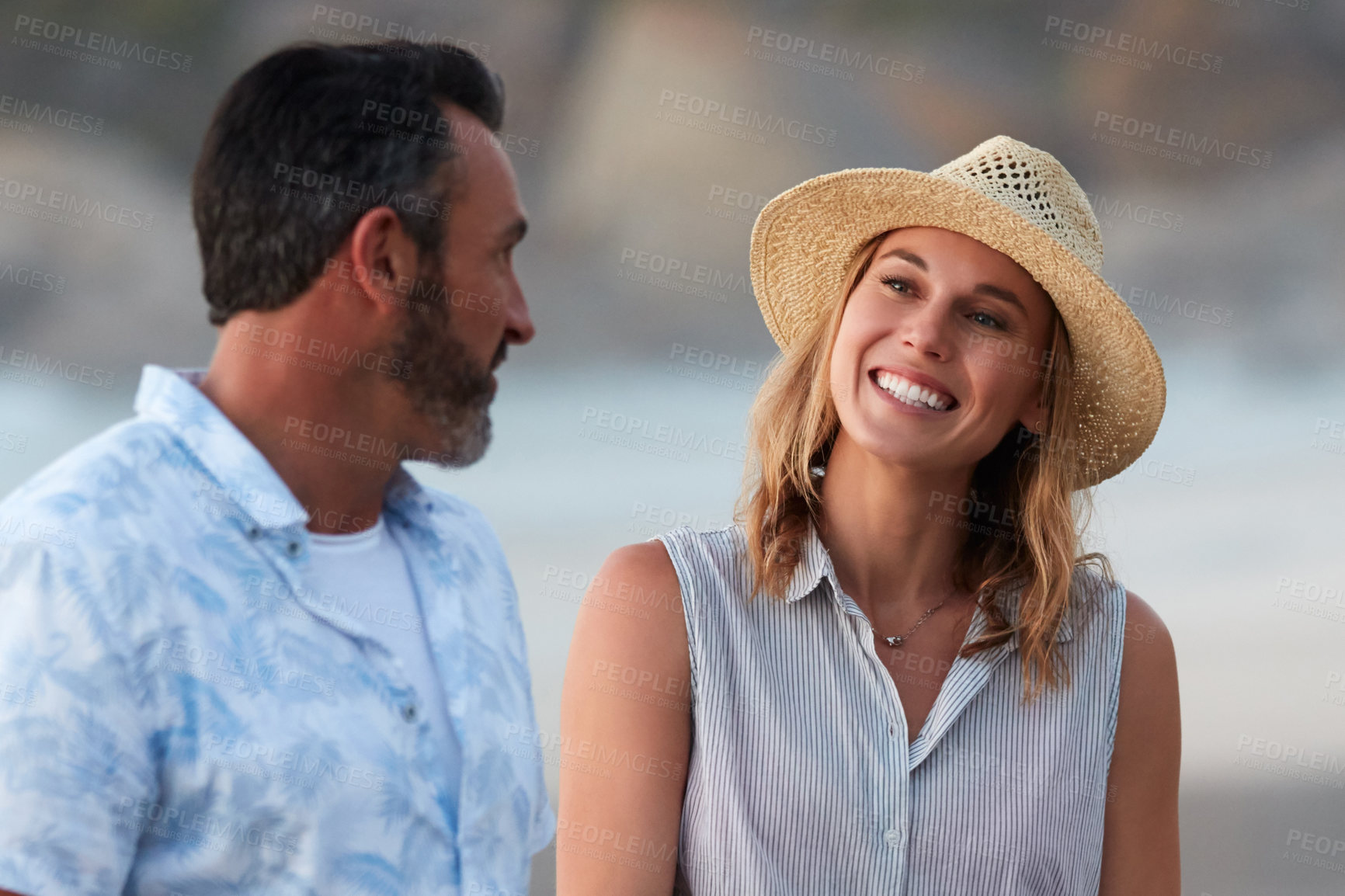 Buy stock photo Shot of an affectionate mature couple taking a walk on the beach