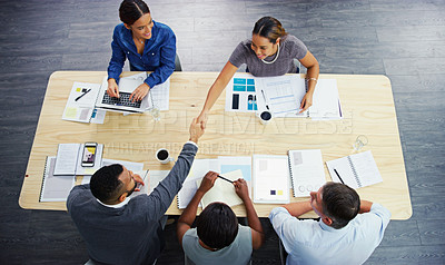 Buy stock photo High angle shot of a group of businesspeople having a meeting around a table at work