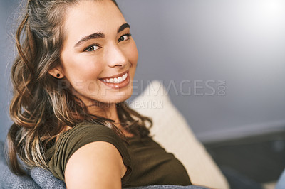 Buy stock photo Portrait of a beautiful young woman relaxing on her sofa at home