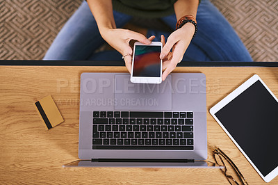 Buy stock photo High angle shot of an unrecognizable woman using a cellphone at her desk at home