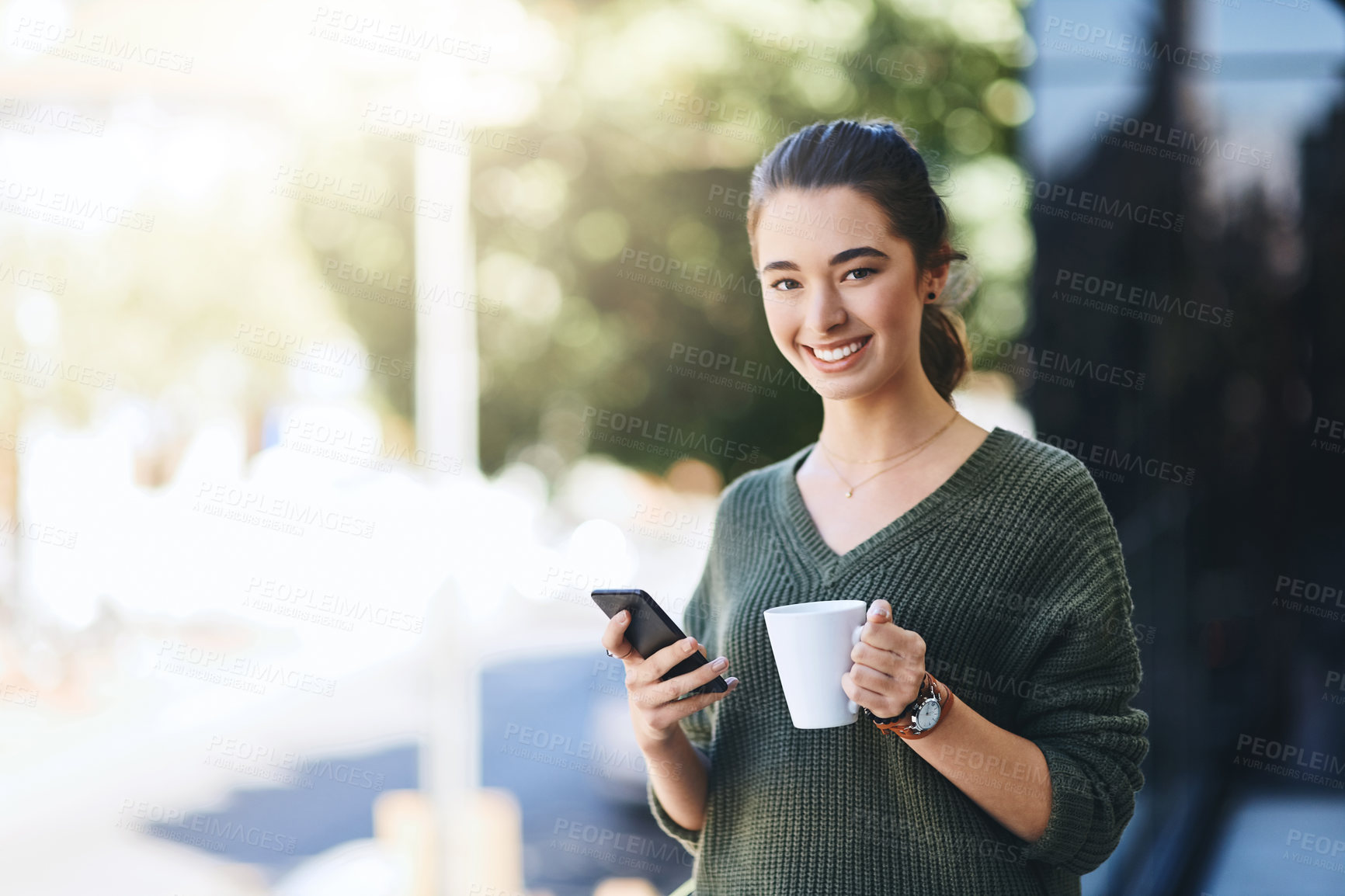 Buy stock photo Portrait of a beautiful young woman enjoying a cup of coffee while using her cellphone outdoors