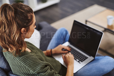 Buy stock photo Girl, laptop and back on sofa in home with blank screen for mockup space, studying and reading in lounge. Woman, student and computer with typing, elearning and education with online course in house