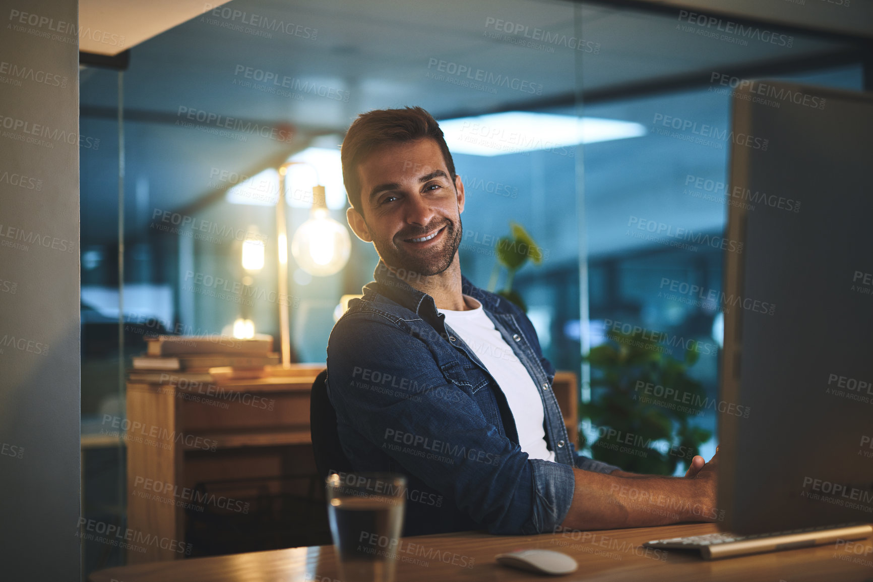 Buy stock photo Computer, night and portrait of happy man in office for software development and troubleshooting of system. Smile, tech and male IT specialist working overtime with online firewall configuration.