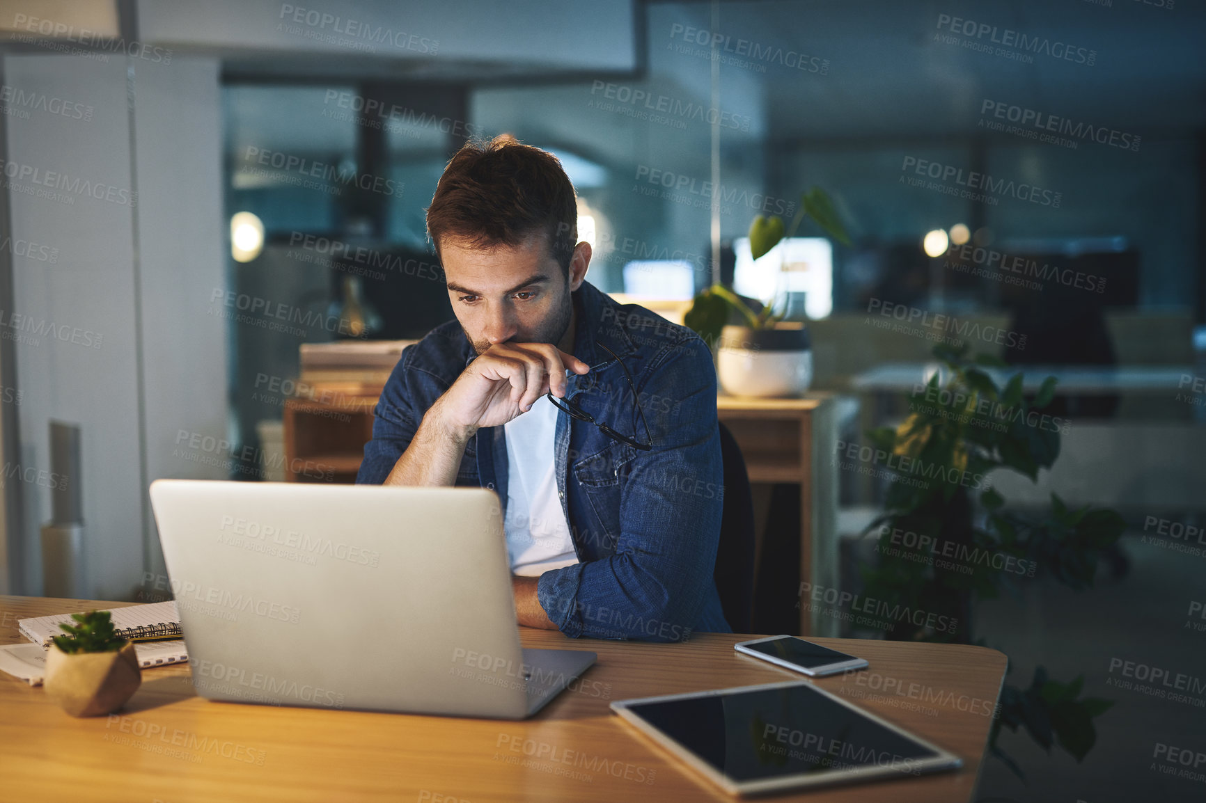 Buy stock photo Night, reading and man in office with laptop, business planning or checking email at digital agency. Thinking, dark and consultant with web report, computer and ideas for online research at desk