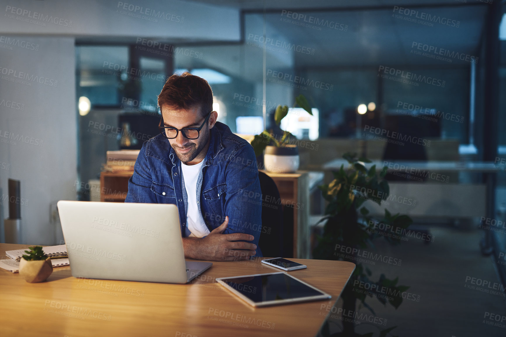 Buy stock photo Night, reading and man at desk with laptop, business planning or checking email at digital agency. Thinking, dark and consultant on web design report with computer, ideas or online research in office