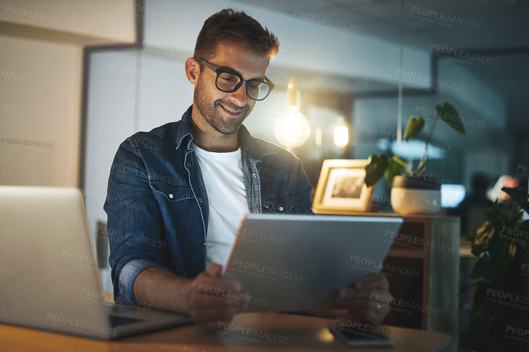 Buy stock photo Office, reading and happy man with tablet, laptop and business ideas for online project at night. Thinking, dark and consultant with digital app for web review, article and  research report at desk