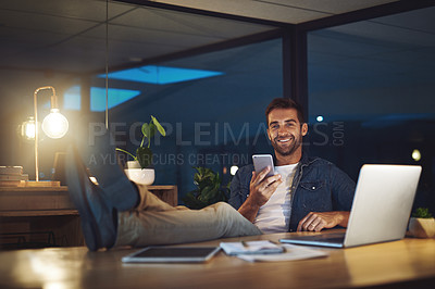 Buy stock photo Night, office and portrait of man with phone, laptop and happy confidence at desk at digital agency. Late, relax and creative consultant with smartphone for scroll, communication or business contact