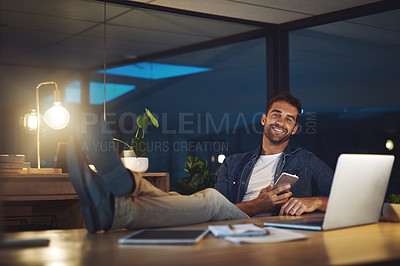 Buy stock photo Night, office and portrait of happy man with phone, laptop and confidence at desk at digital agency. Late, relax and creative consultant with smartphone for scroll, communication or business contact