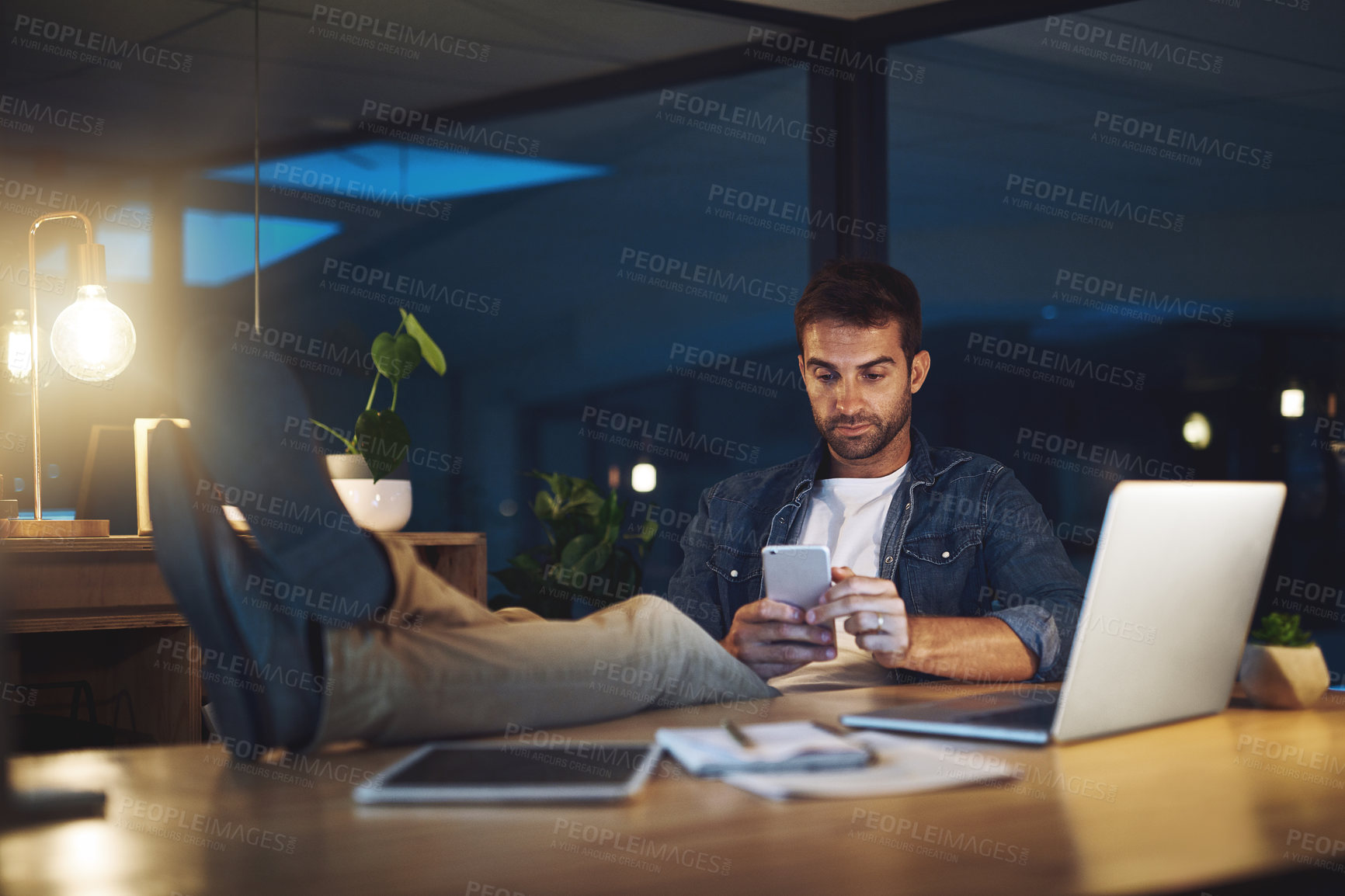 Buy stock photo Office, night and businessman relax with phone for social media, networking and contact. Working late, professional and person on smartphone for online chat, internet research and website on break