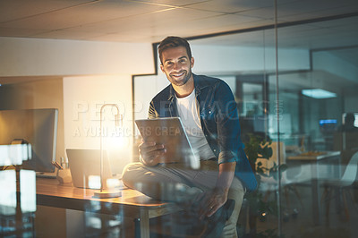 Buy stock photo Shot of a businessman using a digital tablet in his office