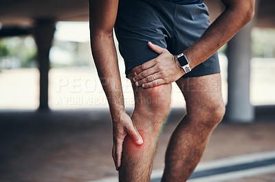 Buy stock photo Closeup shot of an unrecognizable man holding his leg in pain while exercising outdoors