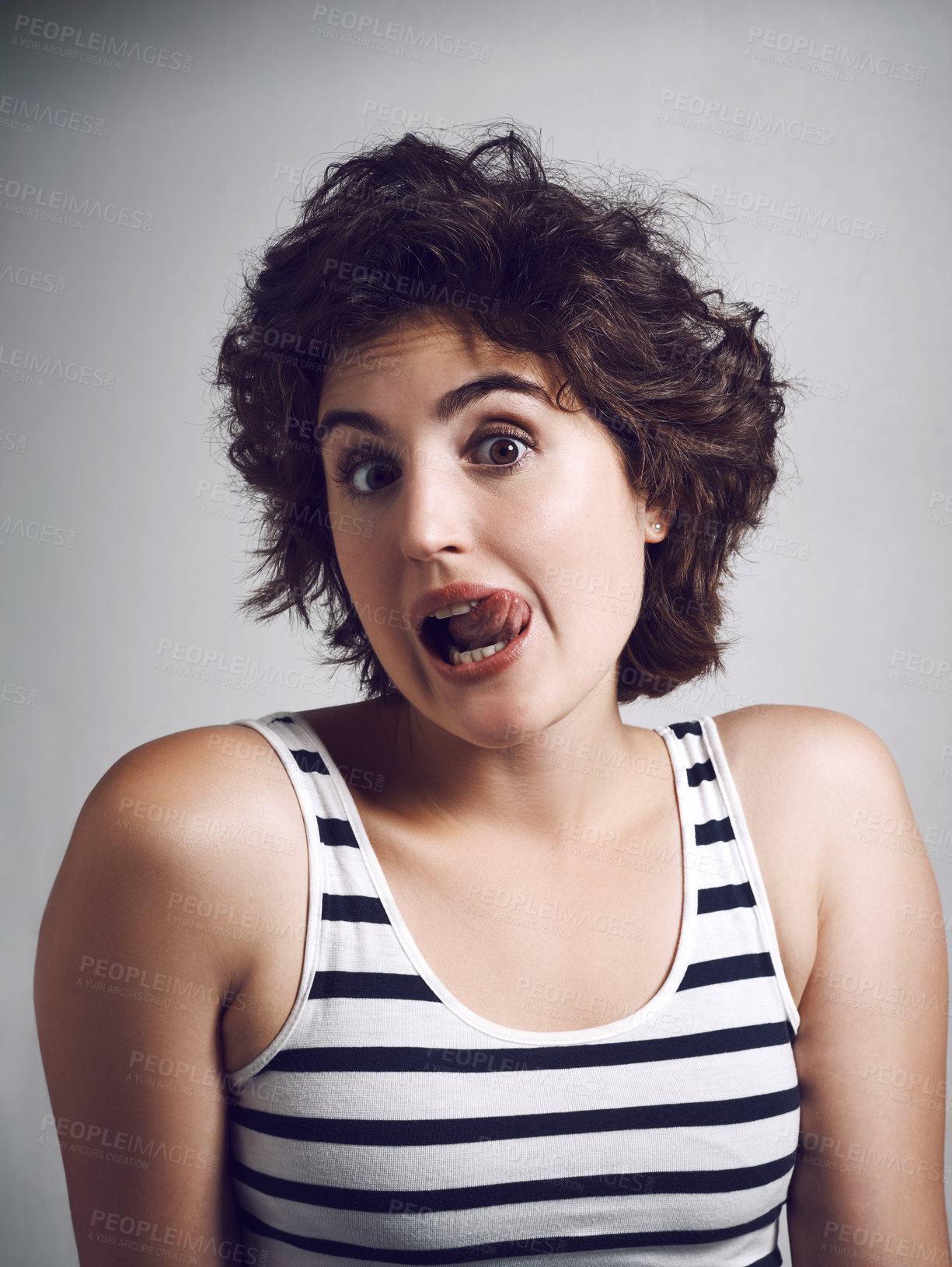 Buy stock photo Woman, portrait and tongue out for playful, goofy and silly as quirky joke, funny face and comedy. Female person, expression and cheerful with emoji, humor and studio background for comic or wellness