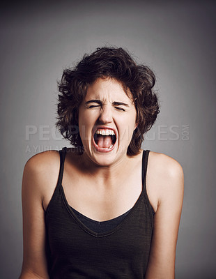 Buy stock photo Studio shot of an attractive young woman screaming with her eyes closed while standing against a grey background
