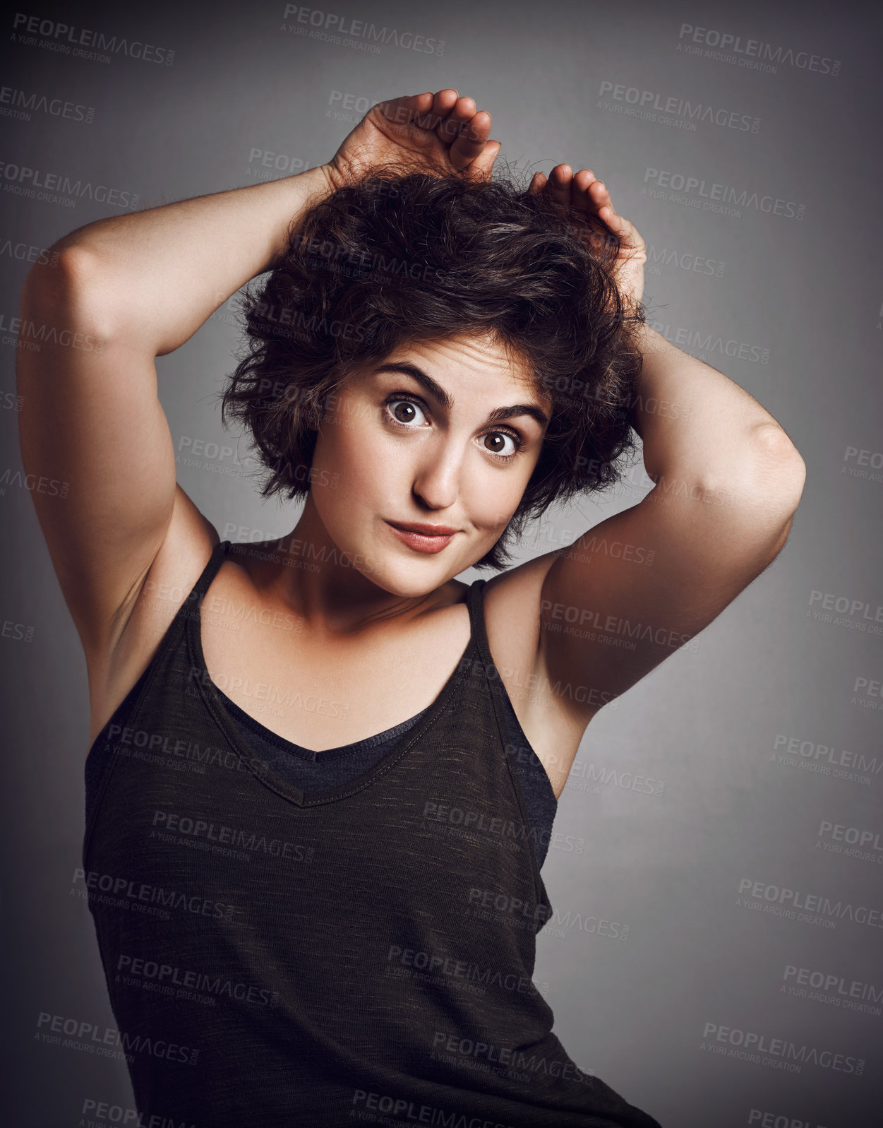 Buy stock photo Studio portrait of an attractive young woman making a funny face with her hands against a grey background