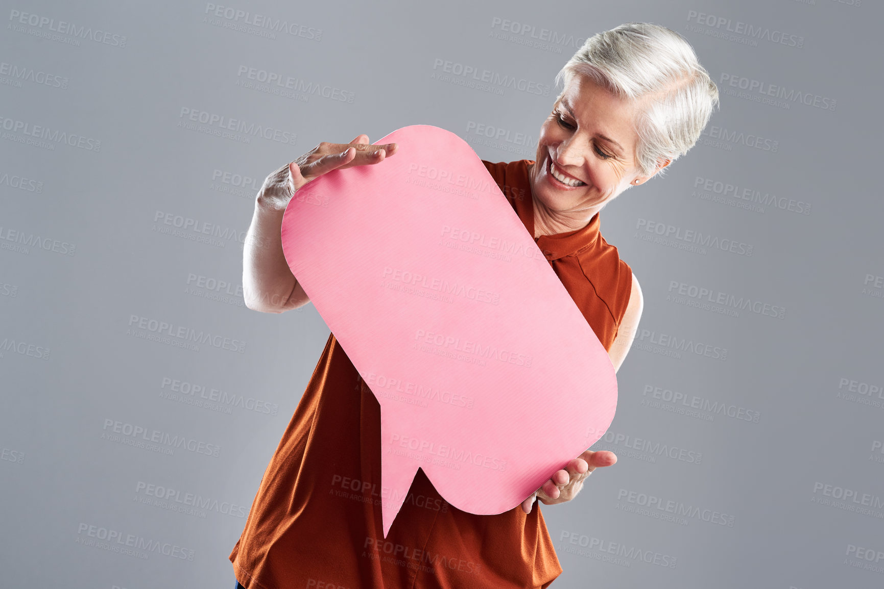 Buy stock photo Speech bubble, poster and business woman in studio for news, forum and company feedback. Mockup, FAQ and happy person with sign for information dialogue, promotion and social media on gray background