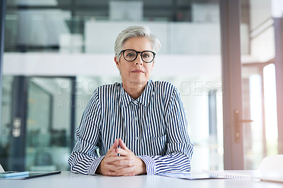 Buy stock photo Portrait of an attractive mature businesswoman sitting at her office desk at work