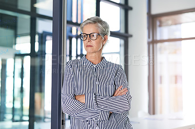 Buy stock photo Shot of an attractive mature businesswoman posing with her arms folded in her office