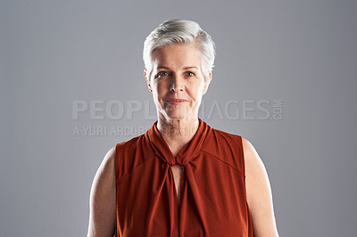 Buy stock photo Portrait of an attractive mature woman posing against a grey background