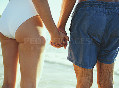 Buy stock photo Closeup shot of a couple holding hands at the beach