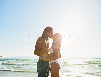 Buy stock photo Couple, kiss and embrace at beach outdoor for romance date, sea water and support of tropical vacation. Happy, woman and man with passion for loyalty, bonding together and summer travel of location