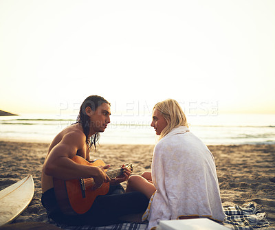 Buy stock photo Couple, music and picnic on beach for love, support and milestone in relationship at sunset. Man, woman or guitar at ocean for serenade, summer vacation or performance in evening on sand in Australia