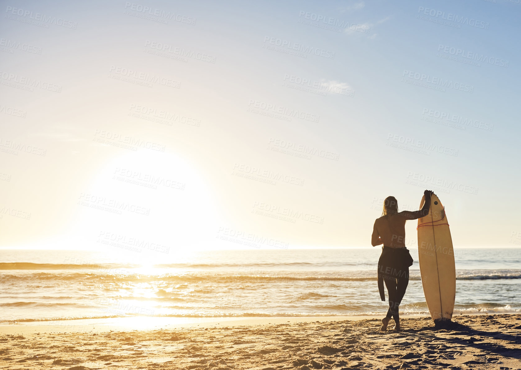 Buy stock photo Beach, man and surfer for surfing as hobby or sports in on back view in Australia. Male person, ocean and recreation in sunset for fitness, exercise and training for tournament, competition and games