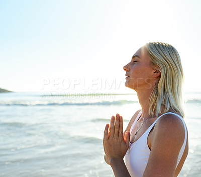 Buy stock photo Cropped shot of an attractive young woman meditating early in the morning on the beach
