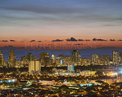 Buy stock photo Copy space with twilight night sky over the view of a coastal city. Scenic panoramic landscape of lights illuminating an urban skyline along the sea. Illuminated Waikiki, Oahu, Hawaii, USA in the dark