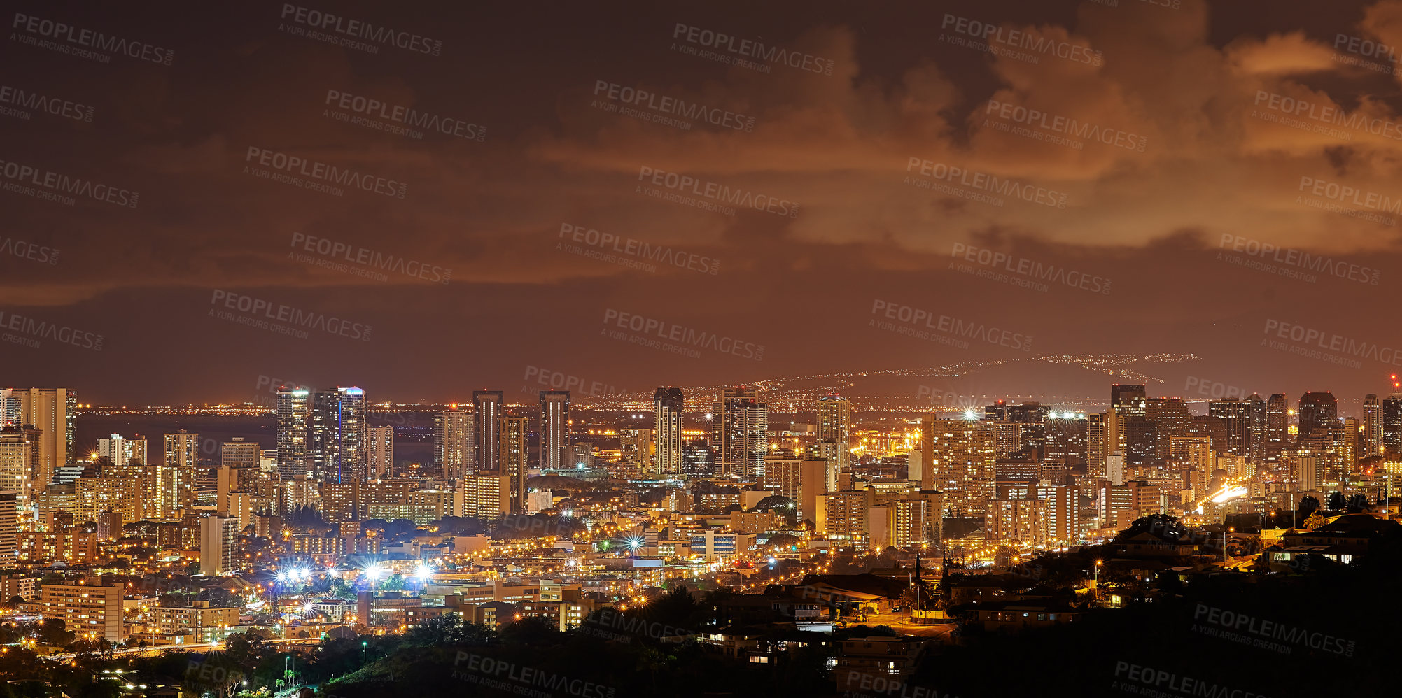 Buy stock photo Copy space with night sky over the view of a coastal city. Scenic landscape of lights illuminating an urban skyline along the sea. Cityscape of Waikiki, Oahu, Hawaii, USA lighting up in the dark