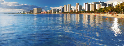 Buy stock photo Panoramic view of the famous Waikiki beach from the ocean at water level. The turquoise color of the tropical waters of the Pacific Ocean. Tourists destination on the soft sand of a tropical resort