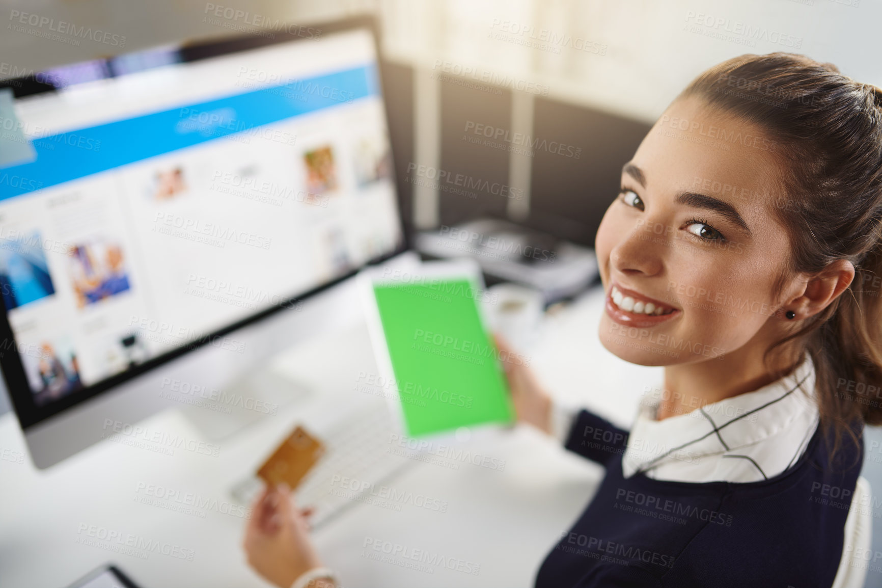 Buy stock photo Portrait of an attractive young businesswoman holding a bank card and a tablet in a modern office