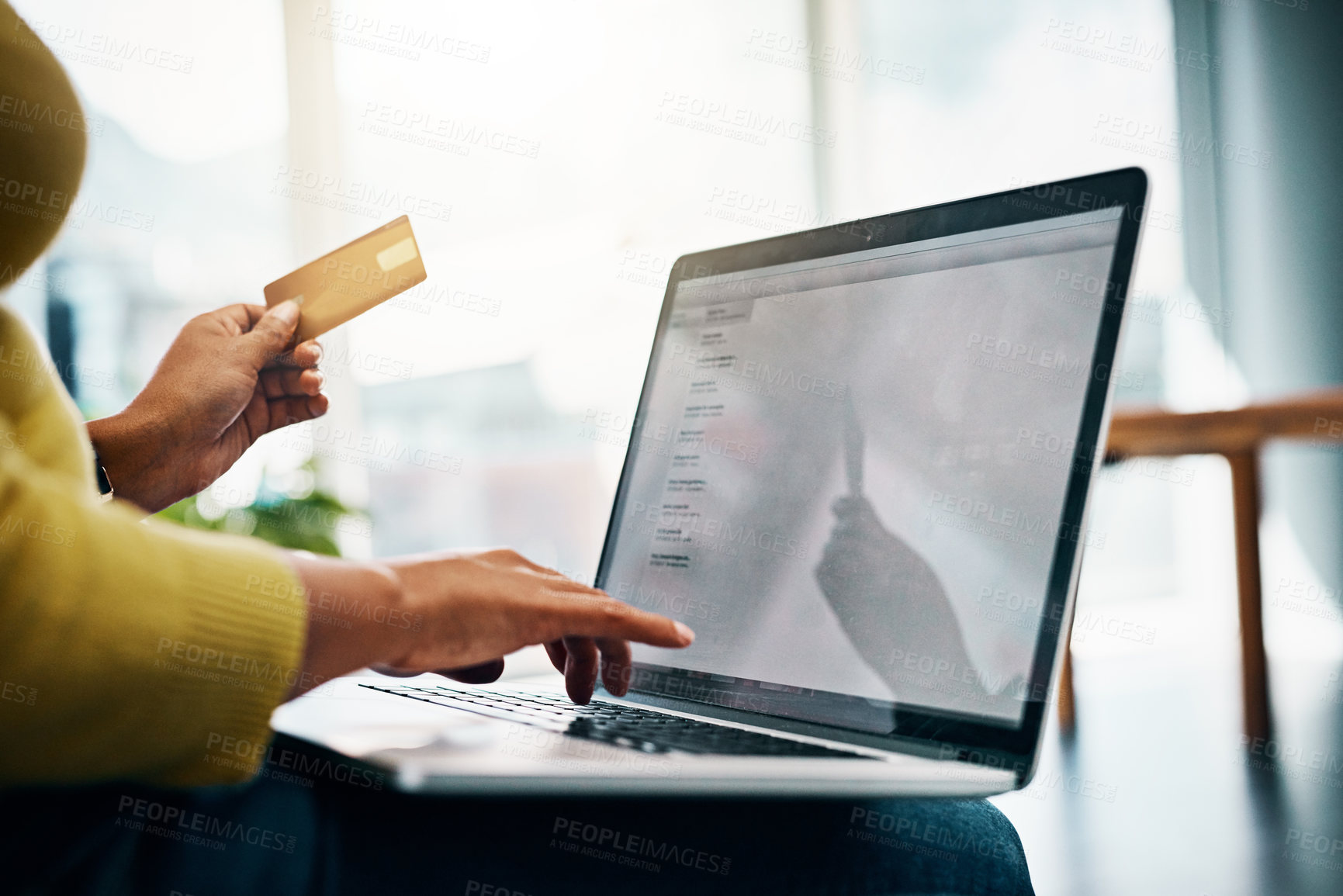 Buy stock photo Cropped shot of a woman using her credit card to make an online payment at home