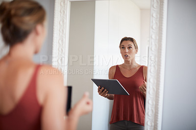 Buy stock photo Cropped shot of an attractive young woman having a rehearsal in the mirror while holding a digital tablet