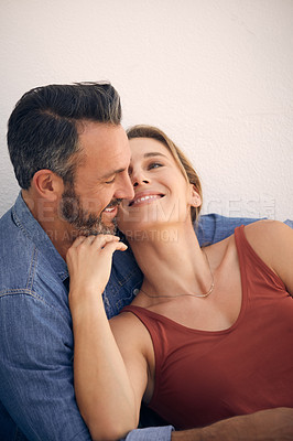 Buy stock photo Cropped shot of an affectionate mature man embracing his wife while sitting outdoors