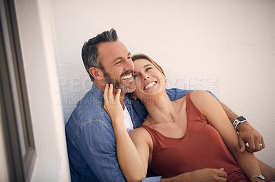 Buy stock photo Cropped shot of an affectionate mature man embracing his wife while sitting outdoors
