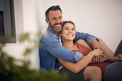 Buy stock photo Cropped shot of an affectionate mature man embracing his wife while sitting outdoors