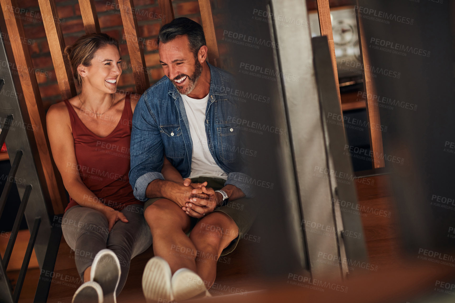 Buy stock photo Shot of a middle aged couple having a good time while relaxing on the floor indoors