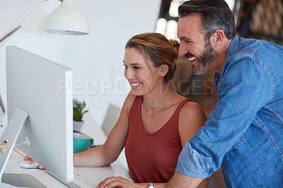 Buy stock photo Cropped shot of a happy middle aged couple using a computer together at home