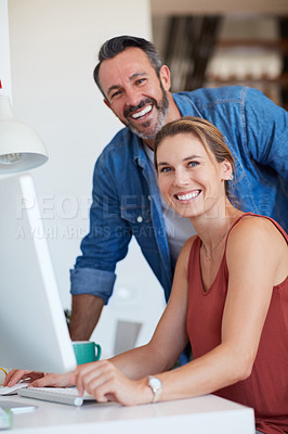 Buy stock photo Portrait of an attractive young woman sitting on a computer with her husband standing beside her