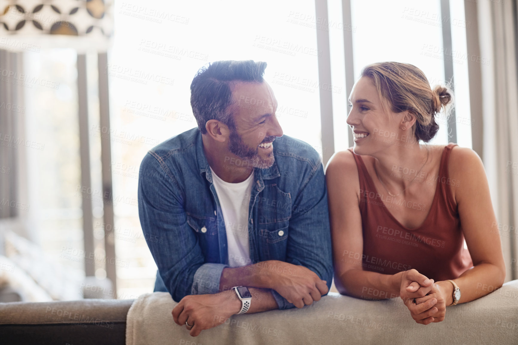 Buy stock photo Shot of a happy couple relaxing on the sofa at home