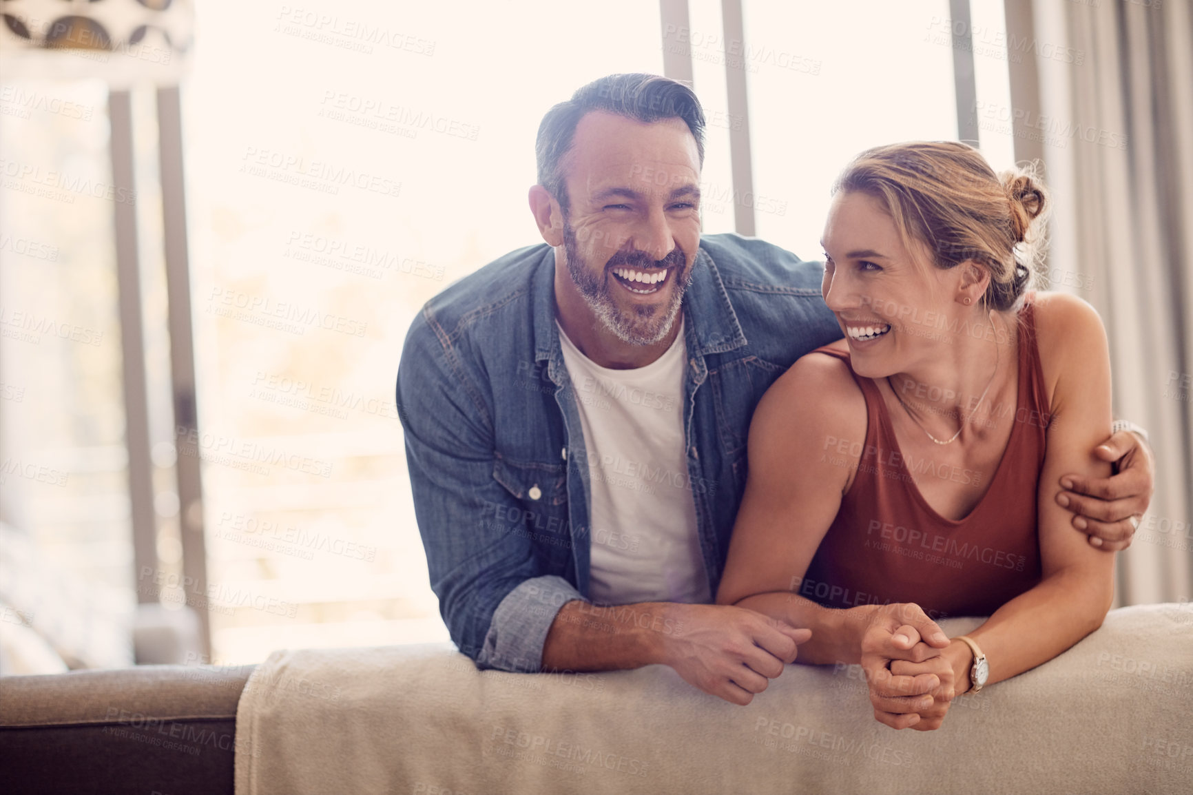 Buy stock photo Shot of a happy couple relaxing on the sofa at home