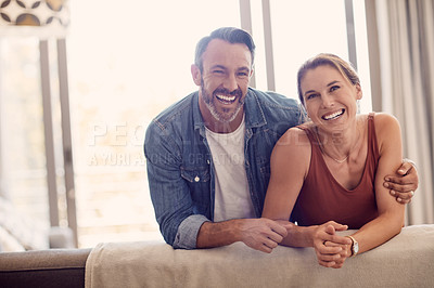 Buy stock photo Shot of a happy couple relaxing on the sofa at home