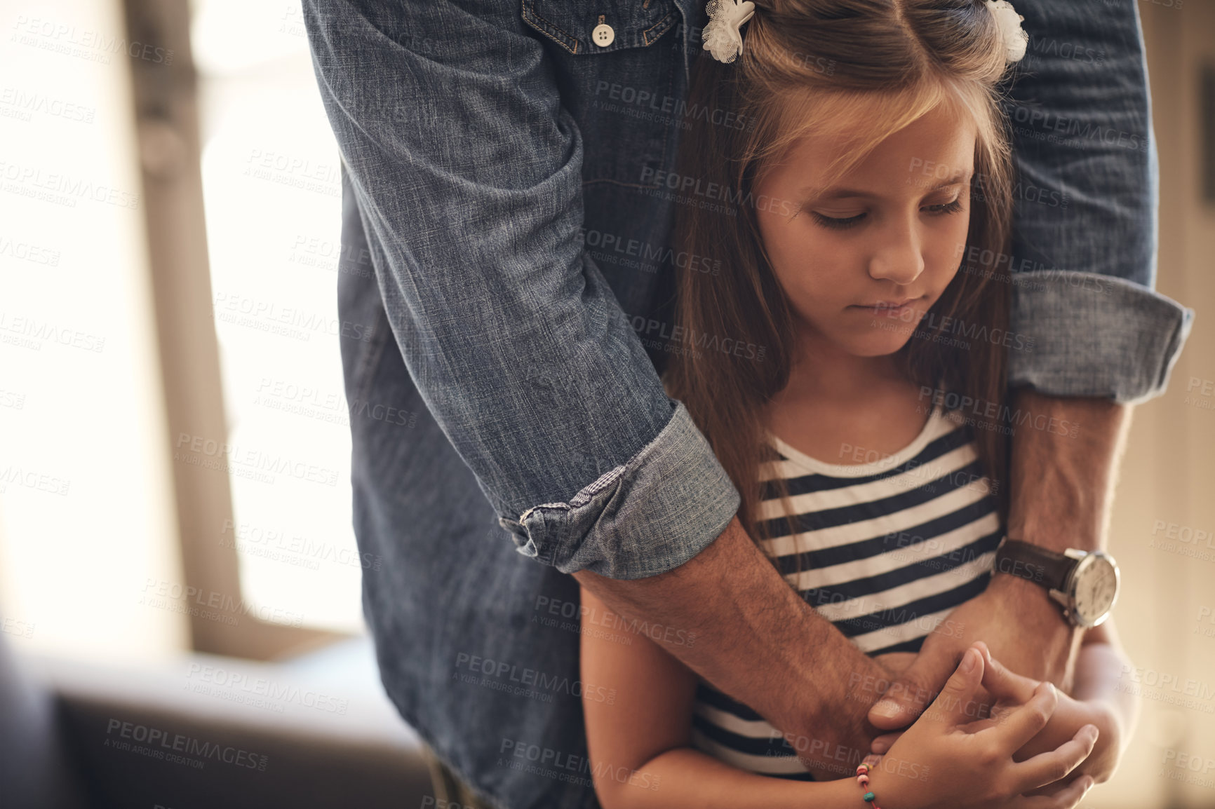 Buy stock photo Girl, kid and sad with hands for comfort in home for emotional support, hug and console with parenting. Family, child and person with embrace for security, safety and problem with compassion in house